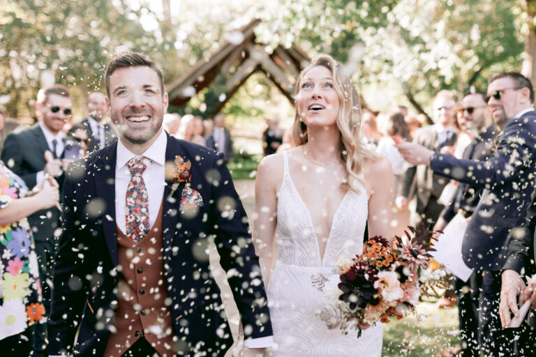 J & Z - By Catherine Carter Weddings-440 Beautiful couple enjoying their confetti toss at their autumnal wedding at Millbridge Court in Surrey